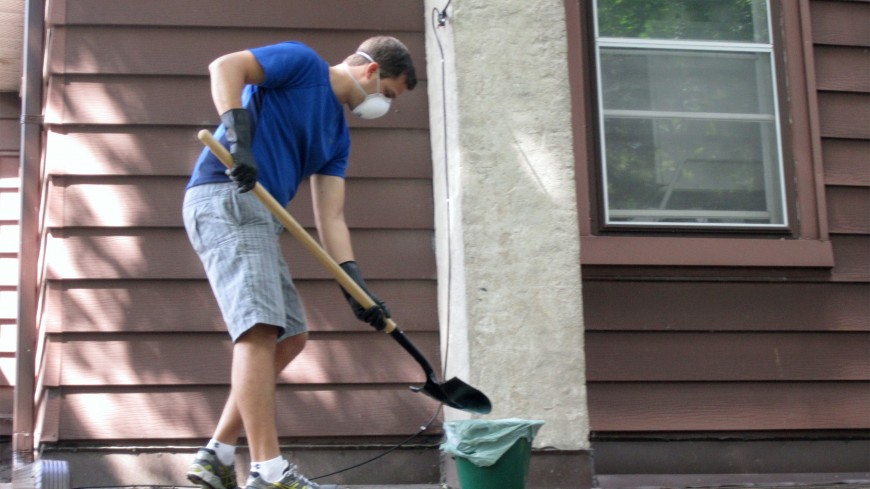 Chris cleaning up the mess left by the raccoons